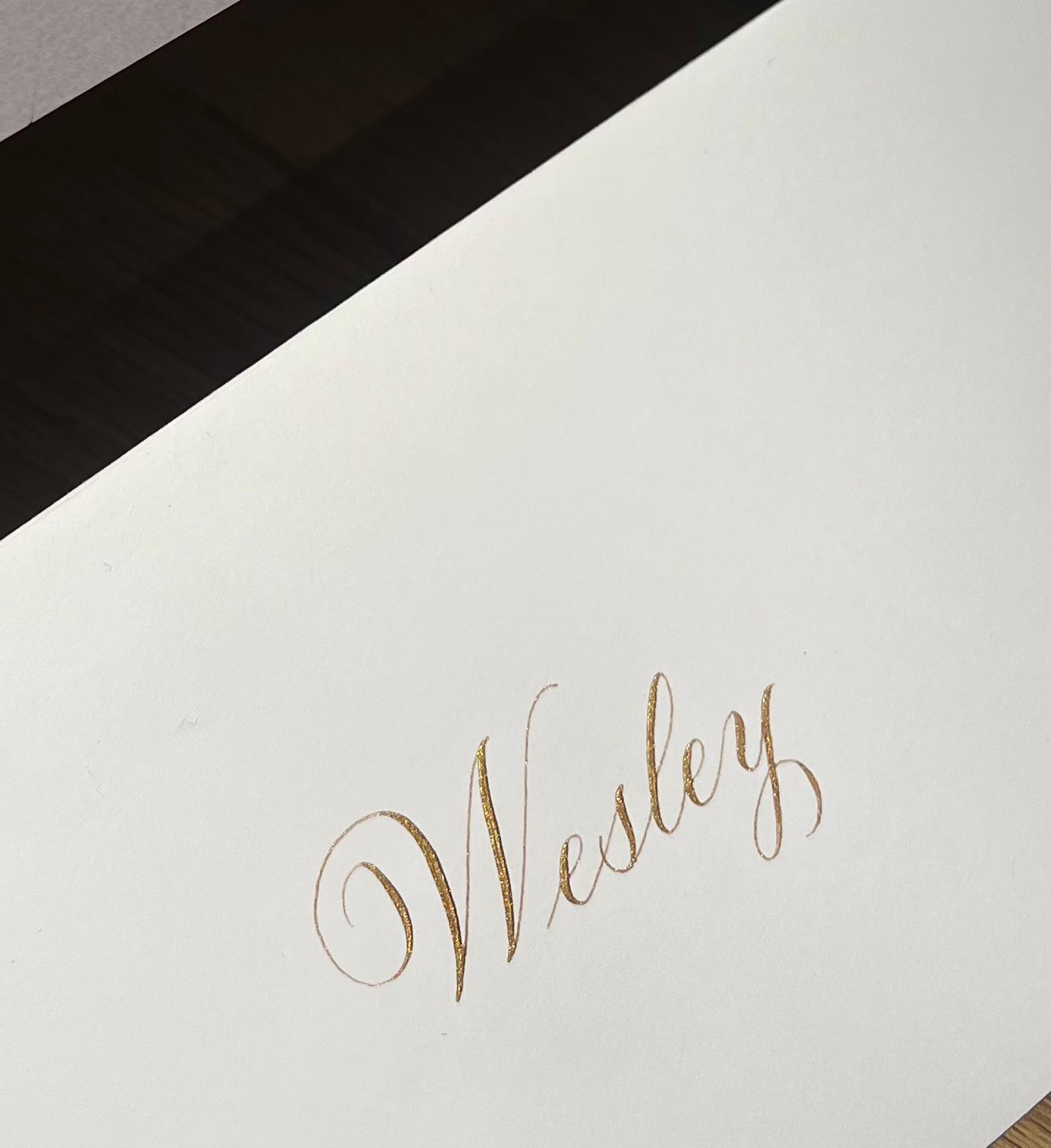 Gold calligraphy on white card - studio work