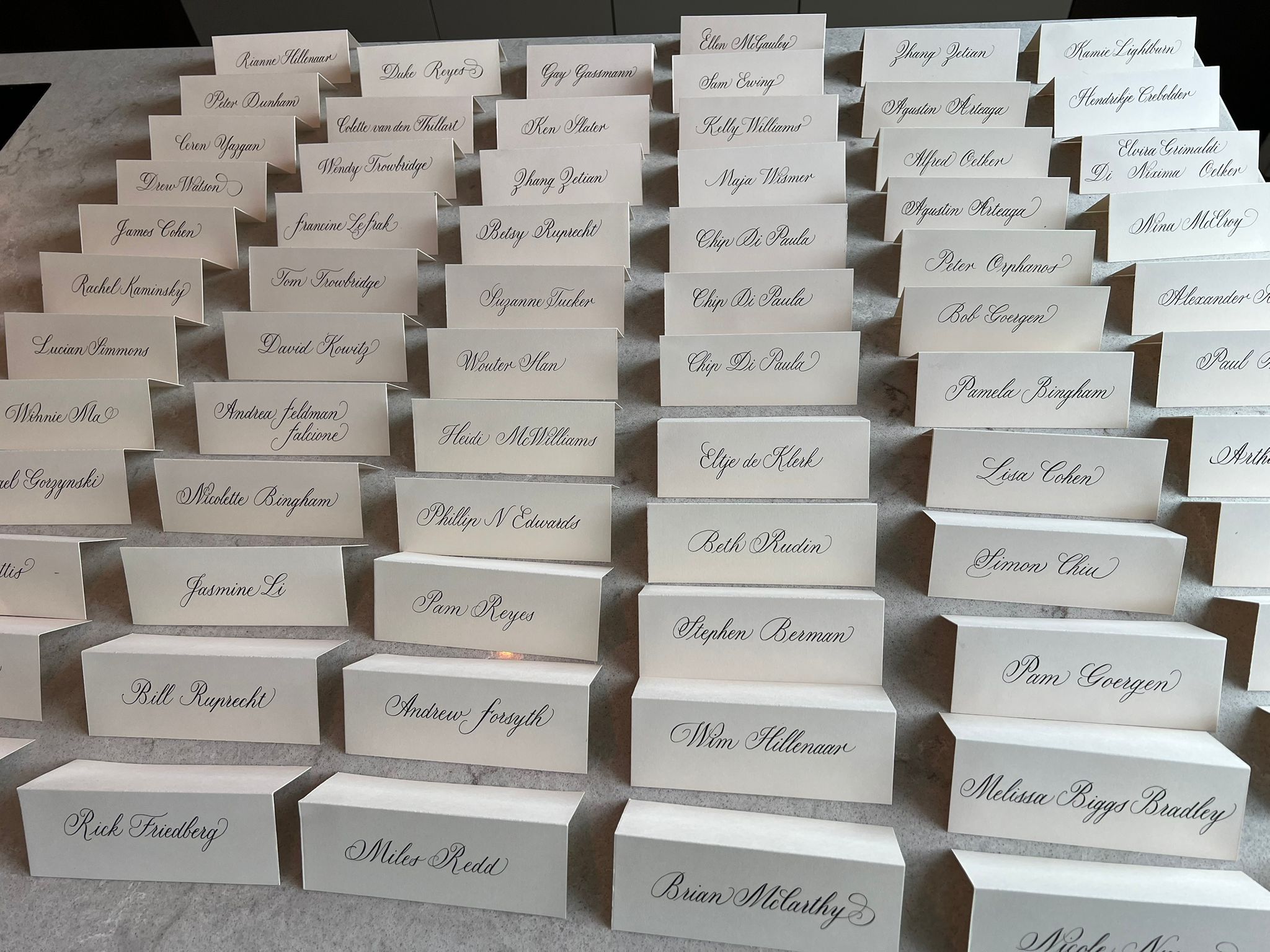 Full table of handwritten calligraphy place cards